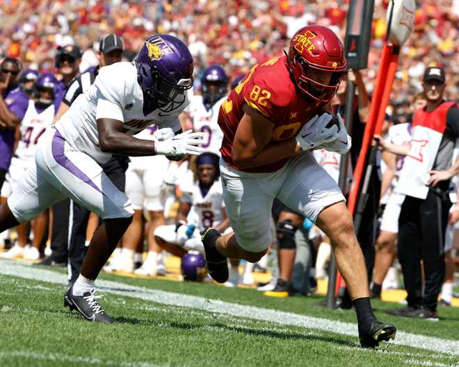 AMES,&#x20;IA&#x20;-&#x20;SEPTEMBER&#x20;2&#x3A;&#x20;Tight&#x20;end&#x20;Tyler&#x20;Moore&#x20;&#x23;82&#x20;of&#x20;the&#x20;Iowa&#x20;State&#x20;Cyclones&#x20;drives&#x20;the&#x20;ball&#x20;into&#x20;the&#x20;end&#x20;zone&#x20;for&#x20;a&#x20;touchdown&#x20;as&#x20;defensive&#x20;back&#x20;Brodrick&#x20;Calhoun&#x20;&#x23;14&#x20;of&#x20;Northern&#x20;Iowa&#x20;defends&#x20;in&#x20;the&#x20;first&#x20;half&#x20;of&#x20;play&#x20;at&#x20;Jack&#x20;Trice&#x20;Stadium&#x20;on&#x20;September&#x20;2,&#x20;2023&#x20;in&#x20;Ames,&#x20;Iowa.&#x20;&#x28;Photo&#x20;by&#x20;David&#x20;Purdy&#x2F;Getty&#x20;Images&#x29;