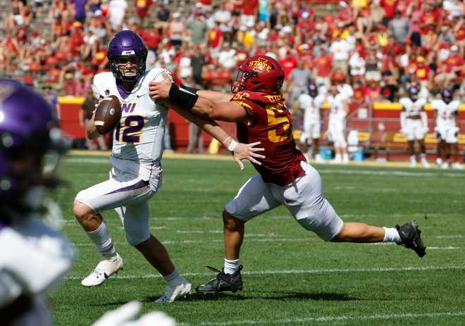 AMES,&#x20;IA&#x20;-&#x20;SEPTEMBER&#x20;2&#x3A;&#x20;Quarterback&#x20;Theo&#x20;Day&#x20;&#x23;12&#x20;of&#x20;the&#x20;Northern&#x20;Iowa&#x20;Panthers&#x20;scrambles&#x20;under&#x20;pressure&#x20;from&#x20;defensive&#x20;end&#x20;Joey&#x20;Petersen&#x20;&#x23;52&#x20;of&#x20;the&#x20;Iowa&#x20;State&#x20;Cyclones&#x20;in&#x20;the&#x20;second&#x20;half&#x20;of&#x20;play&#x20;at&#x20;Jack&#x20;Trice&#x20;Stadium&#x20;on&#x20;September&#x20;2,&#x20;2023&#x20;in&#x20;Ames,&#x20;Iowa.&#x20;The&#x20;Iowa&#x20;State&#x20;Cyclones&#x20;won&#x20;30-9&#x20;over&#x20;the&#x20;Northern&#x20;Iowa&#x20;Panthers.&#x28;Photo&#x20;by&#x20;David&#x20;Purdy&#x2F;Getty&#x20;Images&#x29;