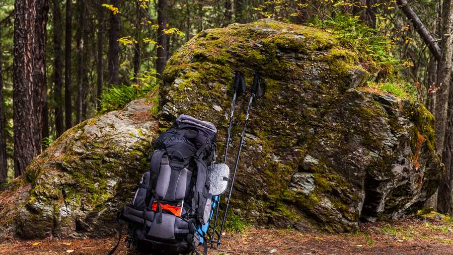 tourist backpack with a tent and sleeping bag in the autumn mountains