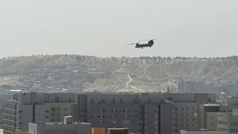 A U.S. Chinook military helicopter flies above the US embassy in Kabul