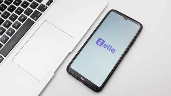 In this photo illustration a Zelle logo seen displayed on a smartphone screen on a desk next to a Macbook in Athens, Greece on September 29, 2022.