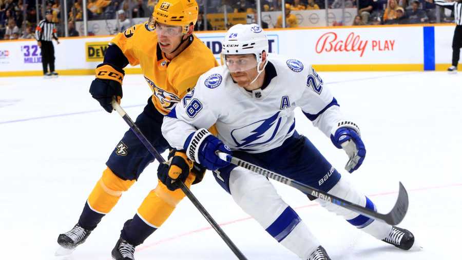NASHVILLE, TN - SEPTEMBER 30: Nashville Predators defenseman Adam Wilsby (83) and Tampa Bay Lightning defenseman Ian Cole (28) battle for position during the NHL preseason game between the Nashville Predators and Tampa Bay Lightning, held September 30, 2022, at Bridgestone Arena in Nashville, Tennessee. (Photo by Danny Murphy/Icon Sportswire via Getty Images)