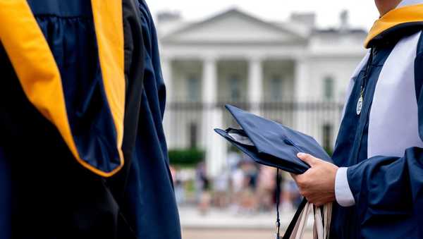 Students wear their graduation gowns