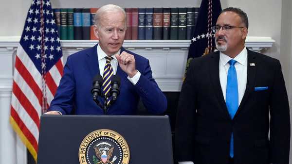 US President Joe Biden announces student loan relief with Education Secretary Miguel Cardona (R) on August 24, 2022 in the Roosevelt Room of the White House in Washington, DC. - Biden announced that most US university graduates still trying to pay off student loans will get $10,000 of relief to address a decades-old headache of massive educational debt across the country. (Photo by OLIVIER DOULIERY / AFP) (Photo by OLIVIER DOULIERY/AFP via Getty Images)