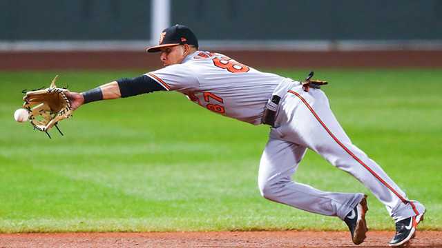 boston, ma - september 23: ramón urías #87 of the baltimore orioles makes a diving stop in the seventh inning of a game against the boston red sox at fenway park on september 23, 2020 in boston, massachusetts.