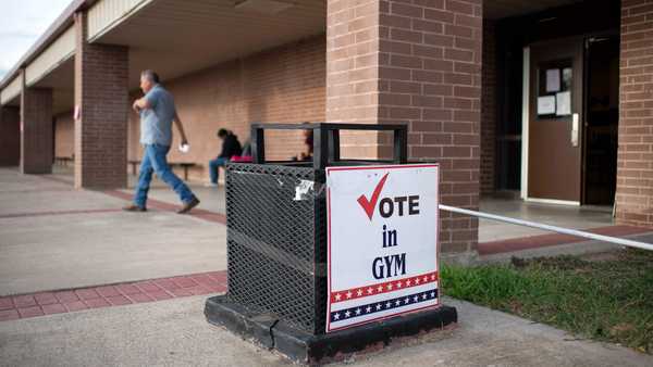 Voters leave the polling station after casting their ballot in the US midterm election, at Memorial Jr. High School in Eagle Pass, Texas, on November 8, 2022. (Photo by Mark Felix / AFP) (Photo by MARK FELIX/AFP via Getty Images)