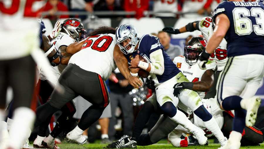 TAMPA, FL - JANUARY 16: Vita Vea #50 of the Tampa Bay Buccaneers tackles Dak Prescott #4 of the Dallas Cowboys during the second quarter of an NFL wild card playoff football game at Raymond James Stadium on January 16, 2023 in Tampa, Florida. (Photo by Kevin Sabitus/Getty Images)