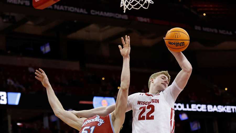 MADISON, WISCONSIN - MARCH 14: Steven Crowl #22 of the Wisconsin Badgers grabs a rebound over Rienk Mast #51 of the Bradley Braves during the second half of the game at Kohl Center on March 14, 2023 in Madison, Wisconsin. (Photo by John Fisher/Getty Images)