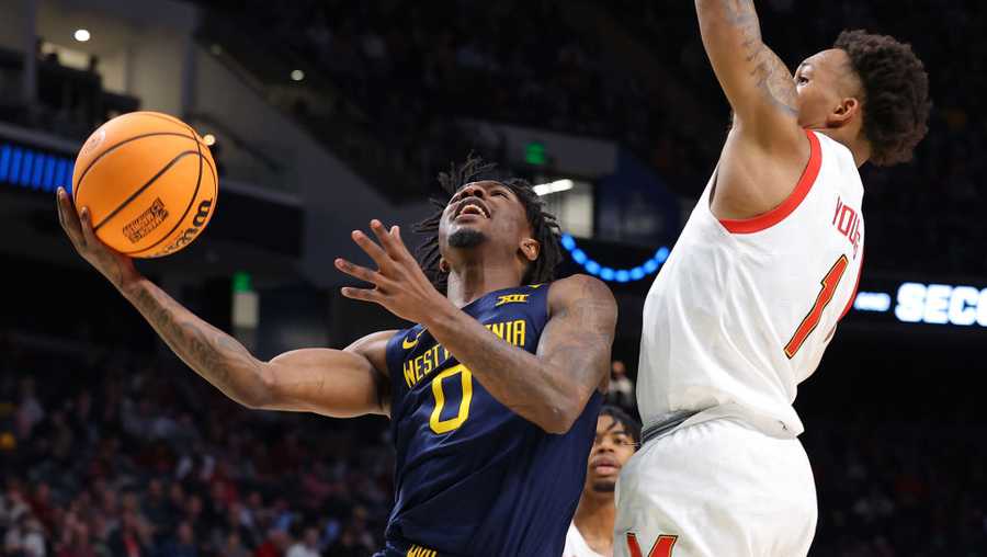 Kedrian Johnson #0 of the West Virginia Mountaineers shoots the ball against Jahmir Young #1 of the Maryland Terrapins during the second half in the first round of the NCAA Men's Basketball Tournament at Legacy Arena at the BJCC on March 16, 2023 in Birmingham, Alabama.
