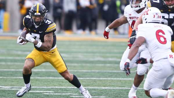 IOWA CITY, IOWA- NOVEMBER 11:  Wide receive Kaleb Brown #3 of the Iowa Hawkeyes goes up the field during the first half against  defensive back Shaquan Loyal #6 of the Rutgers Scarlet Knights at Kinnick Stadium on November 11, 2023 in Iowa City, Iowa.  (Photo by Matthew Holst/Getty Images)