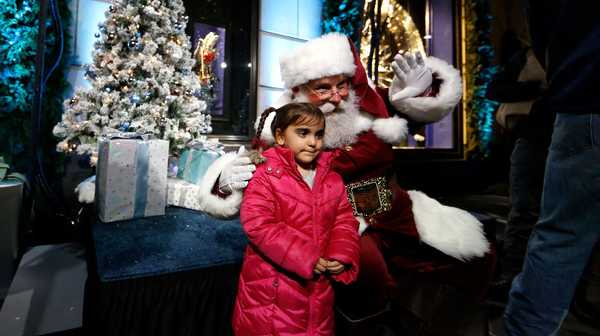 NEW YORK, NEW YORK - NOVEMBER 16: A child poses with Santa Calus during Bergdorf Goodman's 2023 holiday window unveiling at Bergdorf Goodman on November 16, 2023 in New York City. (Photo by John Lamparski/Getty Images)