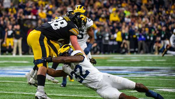 INDIANAPOLIS, INDIANA - DECEMBER 02: Hayden Large #88 of the Iowa Hawkeyes attempts to break a tackle by Jaylen Harrell #32 of the Michigan Wolverines during the first half of the Big Ten Championship at Lucas Oil Stadium on December 02, 2023 in Indianapolis, Indiana. (Photo by Aaron J. Thornton/Getty Images)