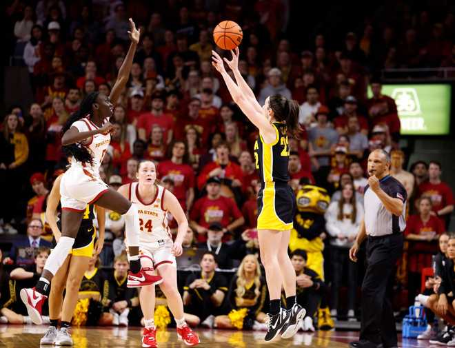 AMES,&#x20;IA&#x20;-&#x20;DECEMBER&#x20;6&#x3A;&#x20;Caitlin&#x20;Clark&#x20;&#x23;22&#x20;of&#x20;the&#x20;Iowa&#x20;Hawkeyes&#x20;shoots&#x20;and&#x20;scores&#x20;on&#x20;a&#x20;three-pointer&#x20;to&#x20;break&#x20;3,000&#x20;career&#x20;points&#x20;against&#x20;Nyamer&#x20;Diew&#x20;&#x23;5&#x20;and&#x20;Addy&#x20;Brown&#x20;&#x23;24&#x20;of&#x20;the&#x20;Iowa&#x20;State&#x20;Cyclones&#x20;in&#x20;the&#x20;second&#x20;half&#x20;at&#x20;Hilton&#x20;Coliseum&#x20;on&#x20;December&#x20;6,&#x20;2023&#x20;in&#x20;Ames,&#x20;Iowa.&#x20;The&#x20;Hawkeyes&#x20;won&#x20;67-58.&#x20;&#x28;Photo&#x20;by&#x20;David&#x20;Purdy&#x2F;Getty&#x20;Images&#x29;