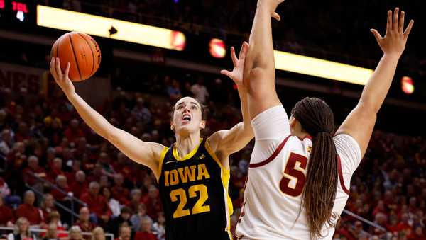 AMES, IA - DECEMBER 6: Caitlin Clark #22 of the Iowa Hawkeyes shoots the ball as Audi Crooks #55 of the Iowa State Cyclones blocks in the first half of play at Hilton Coliseum on December 6, 2023 in Ames, Iowa. They Iowa Hawkeyes won 67-58 over the Iowa State Cyclones. (Photo by David K Purdy/Getty Images)