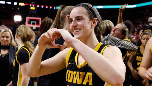 AMES, IA - DECEMBER 6: Caitlin Clark #22 of the Iowa Hawkeyes reacts making a heart with her hands after the Iowa Hawkeyes won 67-58 over the Iowa State Cyclones. Clark became the 15th player in Division I women's basketball history to reach 3,000 points for her career when she broke 3,000 points with a three point basket in the game at Hilton Coliseum on December 6, 2023 in Ames, Iowa. They Iowa Hawkeyes won 67-58 over the Iowa State Cyclones. (Photo by David K Purdy/Getty Images)