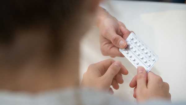 PRODUCTION - 12 December 2023, Bavaria, Planegg: Gynecologist Stephanie Eder gives a young patient the contraceptive pill in her gynecologist's office. Photo: Stefan Puchner/dpa (Photo by Stefan Puchner/picture alliance via Getty Images)