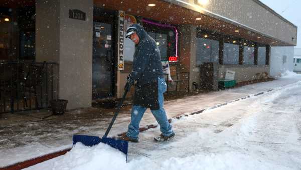 SIOUX CITY, IOWA - JANUARY 08: An employee of the Horizon Family Restaurant works to clear snow outside the venue where Republican presidential candidate former U.N. Ambassador Nikki Haley was scheduled to hold a campaign event on January 8, 2024 in Sioux City, Iowa. The event was cancelled due to inclement weather. Iowa Republicans will be the first to select their party's nominee for the 2024 presidential race when they caucus on January 15, 2024, but heavy snowfall is expected to blanket much of the state today. (Photo by Joe Raedle/Getty Images)