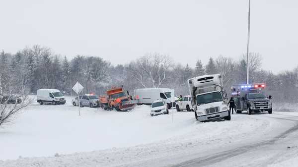 DES MOINES, IOWA - JANUARY 09: Paramedics and law enforcement officers work to dig out a car stuck on an exit ramp near a freeway on January 09, 2024 in Des Moines, Iowa. A weather system is bringing the first winter snowfall to central Iowa as voters prepare for the Republican Party of Iowa's presidential caucuses on January 15th.  (Photo by Anna Moneymaker/Getty Images)