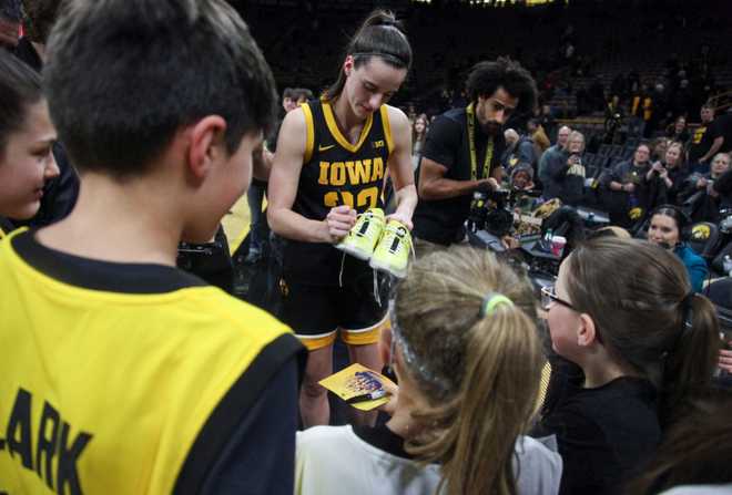 IOWA&#x20;CITY,&#x20;IOWA-&#x20;JANUARY&#x20;16&#x3A;&#x20;&#x20;Guard&#x20;Caitlin&#x20;Clark&#x20;&#x23;22&#x20;of&#x20;the&#x20;Iowa&#x20;Hawkeyes&#x20;signs&#x20;her&#x20;shoes&#x20;before&#x20;giving&#x20;them&#x20;to&#x20;a&#x20;fan&#x20;after&#x20;a&#x20;96-50&#x20;win&#x20;over&#x20;the&#x20;Wisconsin&#x20;Badgers&#x20;at&#x20;Carver-Hawkeye&#x20;Arena&#x20;on&#x20;January&#x20;16,&#x20;2024&#x20;in&#x20;Iowa&#x20;City,&#x20;Iowa.&#x20;&#x20;&#x28;Photo&#x20;by&#x20;Matthew&#x20;Holst&#x2F;Getty&#x20;Images&#x29;