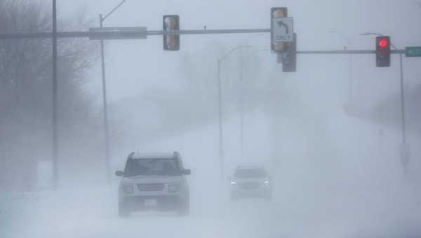 WEST DES MOINES, IOWA - JANUARY 13: Motorists navigate through blowing snow during a cold windy day on January 13, 2024 in West Des Moines, Iowa. Temperatures are expected to drop to around -20 degrees tonight and remain below 0 through Monday. (Photo by Scott Olson/Getty Images)