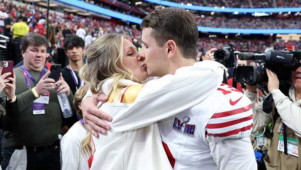 LAS VEGAS, NEVADA - FEBRUARY 11: Brock Purdy #13 of the San Francisco 49ers kisses fiancee Jenna Brandt before Super Bowl LVIII against the Kansas City Chiefs at Allegiant Stadium on February 11, 2024 in Las Vegas, Nevada. (Photo by Ezra Shaw/Getty Images)