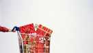 Man pushing supermarket trolley full of Christmas presents, close-up