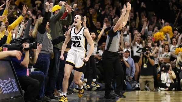 IOWA CITY, IOWA- FEBRUARY 15:  Guard Caitlin Clark #22 of the Iowa Hawkeyes celebrates after breaking the NCAA women's all-time scoring record during the first half against the Michigan Wolverines  at Carver-Hawkeye Arena on February 15, 2024 in Iowa City, Iowa.  (Photo by Matthew Holst/Getty Images)