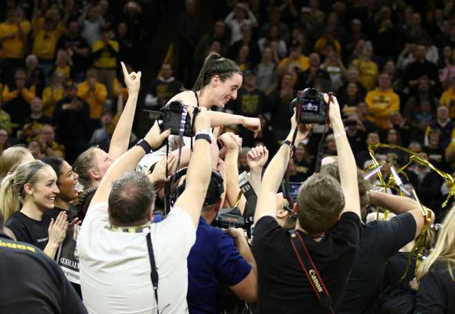 IOWA&#x20;CITY,&#x20;IOWA-&#x20;FEBRUARY&#x20;15&#x3A;&#x20;&#x20;Guard&#x20;Caitlin&#x20;Clark&#x20;&#x23;22&#x20;of&#x20;the&#x20;Iowa&#x20;Hawkeyes&#x20;is&#x20;hoisted&#x20;by&#x20;teammates&#x20;during&#x20;a&#x20;presentation&#x20;after&#x20;breaking&#x20;the&#x20;NCAA&#x20;women&amp;apos&#x3B;s&#x20;all-time&#x20;scoring&#x20;record&#x20;during&#x20;the&#x20;game&#x20;against&#x20;the&#x20;Michigan&#x20;Wolverines&#x20;&#x20;at&#x20;Carver-Hawkeye&#x20;Arena&#x20;on&#x20;February&#x20;15,&#x20;2024&#x20;in&#x20;Iowa&#x20;City,&#x20;Iowa.&#x20;&#x20;&#x28;Photo&#x20;by&#x20;Matthew&#x20;Holst&#x2F;Getty&#x20;Images&#x29;