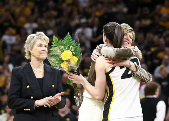 IOWA&#x20;CITY,&#x20;IOWA-&#x20;MARCH&#x20;3&#x3A;&#x20;Associate&#x20;head&#x20;coach&#x20;Jan&#x20;Jensen&#x20;&#x28;C&#x29;&#x20;of&#x20;the&#x20;Iowa&#x20;Hawkeyes&#x20;hugs&#x20;guard&#x20;Caitlin&#x20;Clark&#x20;&#x23;22&#x20;as&#x20;head&#x20;coach&#x20;Lisa&#x20;Bluder&#x20;&#x28;L&#x29;&#x20;looks&#x20;on&#x20;during&#x20;the&#x20;senior&#x20;day&#x20;program&#x20;following&#x20;the&#x20;match-up&#x20;against&#x20;the&#x20;Ohio&#x20;State&#x20;Buckeyes&#x20;at&#x20;Carver-Hawkeye&#x20;Arena&#x20;on&#x20;March&#x20;3,&#x20;2024&#x20;in&#x20;Iowa&#x20;City,&#x20;Iowa.&#x20;&#x28;Photo&#x20;by&#x20;Matthew&#x20;Holst&#x2F;Getty&#x20;Images&#x29;