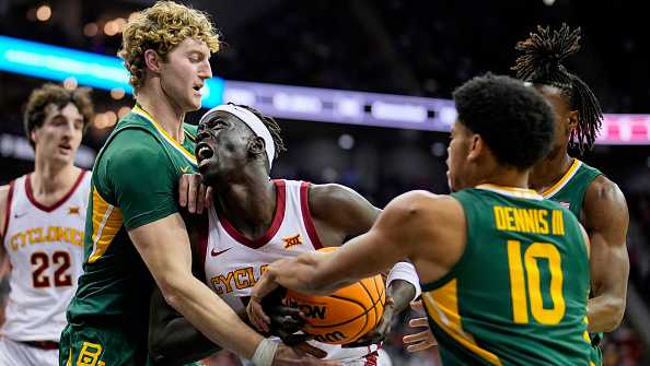 KANSAS CITY, MISSOURI - MARCH 15: Omaha Biliew #33 of the Iowa State Cyclones goes to the basket against Caleb Lohner #33 and RayJ Dennis #10 of the Baylor Bears during the first half of a semifinal game of the Big 12 Men's Basketball Tournament at T-Mobile Center on March 15, 2024 in Kansas City, Missouri.  (Photo by Jay Biggerstaff/Getty Images)