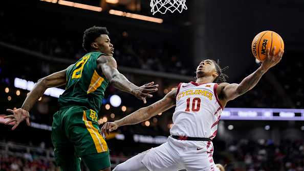 KANSAS CITY, MISSOURI - MARCH 15: Keshon Gilbert #10 of the Iowa State Cyclones shoots against Yves Missi #21 of the Baylor Bears during the first half of a semifinal game of the Big 12 Men's Basketball Tournament at T-Mobile Center on March 15, 2024 in Kansas City, Missouri.  (Photo by Jay Biggerstaff/Getty Images)