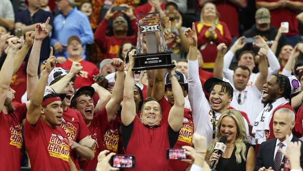 KANSAS CITY, MO - MARCH 16: Iowa State Cyclones head coach T.J. Otzelberger lifts the trophy over his head after winning the Big 12 tournament final against the Houston Cougars on Mar 16, 2024 at T-Mobile Center in Kansas City, MO. (Photo by Scott Winters/Icon Sportswire via Getty Images)