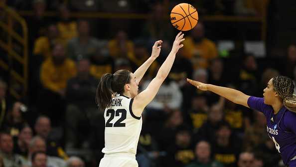 IOWA CITY, IOWA - MARCH 23: Caitlin Clark #22 of the Iowa Hawkeyes shoots the ball over the reach of Simone Foreman #24 of the Holy Cross Crusaders during the first round of the 2024 NCAA Women&apos;s Basketball Tournament held at Carver-Hawkeye Arena on March 23, 2024 in Iowa City, Iowa. (Photo by Rebecca Gratz/NCAA Photos via Getty Images)