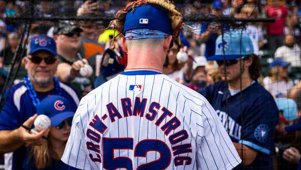 MESA, AZ - FEBRUARY 25: Pete Crow-Armstrong #52 of the Chicago Cubs signs autographs during the 2024 Spring Training Game between San Diego Padres and Chicago Cubs at Sloan Park  on Sunday, February 25, 2024 in Mesa, Arizona. (Photo by Adam Glanzman/MLB Photos via Getty Images)