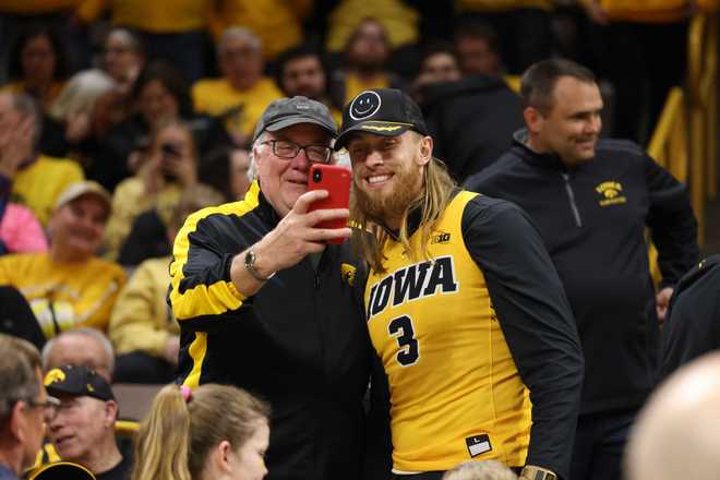 IOWA&#x20;CITY,&#x20;IOWA&#x20;-&#x20;MARCH&#x20;25&#x3A;&#x20;San&#x20;Francisco&#x20;49ers&#x20;tight&#x20;end&#x20;and&#x20;former&#x20;Iowa&#x20;Hawkeyes&#x20;tight&#x20;end&#x20;George&#x20;Kittle&#x20;poses&#x20;for&#x20;photos&#x20;with&#x20;Iowa&#x20;basketball&#x20;fans&#x20;prior&#x20;to&#x20;tipoff&#x20;against&#x20;the&#x20;West&#x20;Virginia&#x20;Mountaneers&#x20;during&#x20;the&#x20;second&#x20;round&#x20;of&#x20;the&#x20;2024&#x20;NCAA&#x20;Women&amp;apos&#x3B;s&#x20;Basketball&#x20;Tournament&#x20;held&#x20;at&#x20;Carver-Hawkeye&#x20;Arena&#x20;on&#x20;March&#x20;25,&#x20;2024&#x20;in&#x20;Iowa&#x20;City,&#x20;Iowa.&#x20;&#x28;Photo&#x20;by&#x20;Rebecca&#x20;Gratz&#x2F;NCAA&#x20;Photos&#x20;via&#x20;Getty&#x20;Images&#x29;