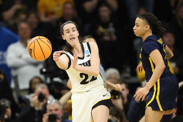 IOWA&#x20;CITY,&#x20;IOWA&#x20;-&#x20;MARCH&#x20;25&#x3A;&#x20;Caitlin&#x20;Clark&#x20;&#x23;22&#x20;of&#x20;the&#x20;Iowa&#x20;Hawkeyes&#x20;passes&#x20;the&#x20;ball&#x20;as&#x20;JJ&#x20;Quinerly&#x20;&#x23;11&#x20;of&#x20;the&#x20;West&#x20;Virginia&#x20;Mountaneers&#x20;defends&#x20;during&#x20;the&#x20;second&#x20;round&#x20;of&#x20;the&#x20;2024&#x20;NCAA&#x20;Women&amp;apos&#x3B;s&#x20;Basketball&#x20;Tournament&#x20;held&#x20;at&#x20;Carver-Hawkeye&#x20;Arena&#x20;on&#x20;March&#x20;25,&#x20;2024&#x20;in&#x20;Iowa&#x20;City,&#x20;Iowa.&#x20;&#x28;Photo&#x20;by&#x20;Rebecca&#x20;Gratz&#x2F;NCAA&#x20;Photos&#x20;via&#x20;Getty&#x20;Images&#x29;