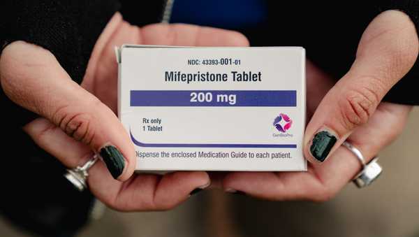 WASHINGTON, DC - MARCH 26: Trans man and abortion rights advocate Artemis Duffy of New England shows a box of mifepristone he is taking outside the Supreme Court in Washington, DC, on March 26, 2024. (Photo by Shuran Huang for The Washington Post via Getty Images)