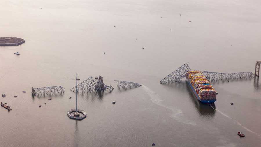 In an aerial view, cargo ship Dali is seen after running into and collapsing the Francis Scott Key Bridge on March 26, 2024 in Baltimore, Maryland. Rescuers are searching for at least seven people, authorities say, while two others have been pulled from the Patapsco River. (Photo by Tasos Katopodis/Getty Images)