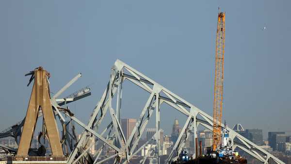 BALTIMORE, MARYLAND - MARCH 29: A crane works on clearing debris from the Francis Scott Key Bridge on March 29, 2024 in Baltimore, Maryland. The bridge collapsed on Tuesday at 1:30AM, after being struck by the massive cargo ship Dali. Two members of a road repair crew were pulled from the Patapsco River immediately after the collision, while two other bodies were pulled from the water on Wednesday and four people remain missing and are presumed dead after the Coast Guard called off rescue efforts. The accident has temporarily closed the Port of Baltimore, one of the largest and busiest on the East Coast of the U.S. (Photo by Kevin Dietsch/Getty Images)