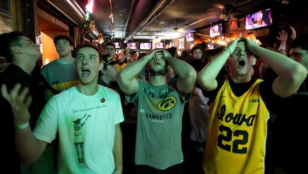 IOWA CITY, IOWA- APRIL 07: University of Iowa students (left to right) Jacob Mall, Ben Ephraim and Eli Mall watch the match-up between the South Carolina Gamecocks and the Iowa Hawkeyes during the 2024 NCAA Division 1 Women's Basketball Championship at The Sports Column Bar on April 7, 2024 in Iowa City, Iowa. (Photo by Matthew Holst/Getty Images)