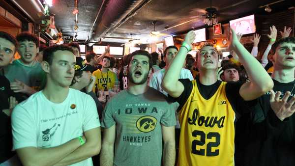 IOWA CITY, IOWA- APRIL 07: University of Iowa students (left to right) Jacob Mall, Ben Ephraim and Eli Mall watch the match-up between the South Carolina Gamecocks and the Iowa Hawkeyes during the 2024 NCAA Division 1 Women's Basketball Championship at The Sports Column Bar on April 7, 2024 in Iowa City, Iowa. (Photo by Matthew Holst/Getty Images)