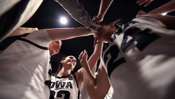 CLEVELAND, OHIO - APRIL 05: Caitlin Clark #22 of the Iowa Hawkeyes huddles with the team after beating the Connecticut Huskies in the NCAA Women's Basketball Tournament Final Four semifinal game at Rocket Mortgage Fieldhouse on April 05, 2024 in Cleveland, Ohio. Iowa defeated Connecticut 71-69. (Photo by Steph Chambers/Getty Images)