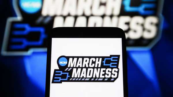In this photo illustration, a March Madness logo is seen
