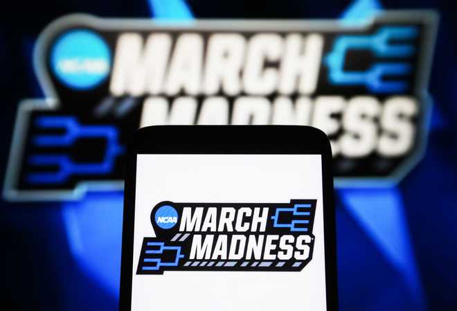 In this photo illustration, a March Madness logo is seen