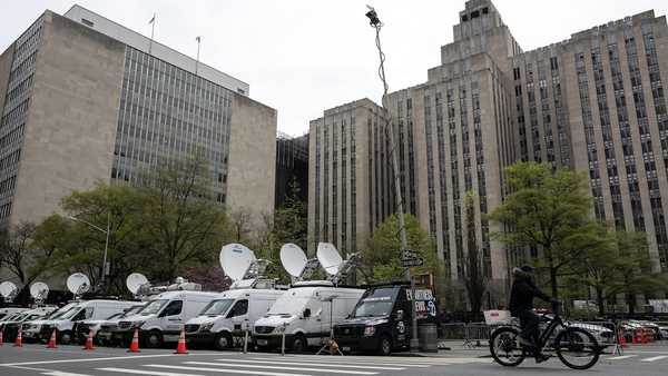 Media vehicles are parked outside of the Manhattan Criminal Court building as former U.S. President Donald Trump attends his trial for allegedly covering up hush money payments linked to extramarital affairs, in New York City on April 19, 2024.