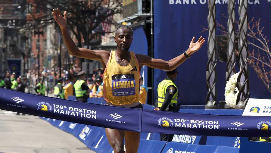 BOSTON, MASSACHUSETTS - APRIL 15: Sisay Lemma of Ethiopia crosses the finish line to win the Professional Men&apos;s Division at the 128th Boston Marathon on April 15, 2024 in Boston, Massachusetts.  (Photo by Paul Rutherford/Getty Images)