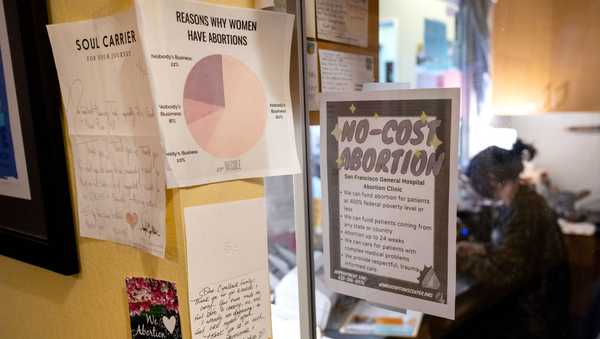 PHOENIX, AZ - APRIL 18, 2024: Information on a no-cost abortion clinic in San Francisco hangs on the glass at the reception area at Camelback Family Planning on April  18, 2024 in Phoenix, Arizona. The clinic will have to cease performing abortions on June 8 if the 1864 law banning abortions isn't delayed or overturned. (Gina Ferazzi / Los Angeles Times via Getty Images)