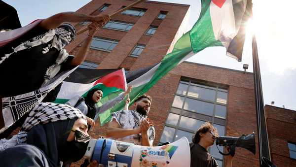 WASHINGTON, DC - MAY 02:  Pro-Palestinian demonstrators celebrate after raising the Palestinian flag outside Lisner Hall as they rally on the campus of George Washington University on May 02, 2024 in Washington, DC. Pro-Palestinian encampments have sprung up at college campuses around the country with some protestors calling for schools to divest from Israeli interests amid the ongoing war in Gaza.  (Photo by Chip Somodevilla/Getty Images)