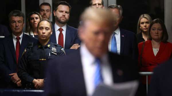 Senator J.D. Vance (center,red tie)(R-OH) looks on as former US President Donald Trump speaks to the media at his trial for allegedly covering up hush money payments at Manhattan Criminal Court, in New York City, on May 13, 2024. Donald Trump's criminal trial in New York was expected to hear his former lawyer turned tormentor Michael Cohen testify Monday about his role in what prosecutors say was a cover up of payments to hide an affair. (Photo by Spencer Platt / POOL / AFP) (Photo by SPENCER PLATT/POOL/AFP via Getty Images)