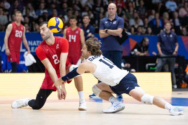 OTTAWA, ONTARIO - JUNE 08: Aaron Russell #2 and Kyle Dagostino #10 of the United States misplay a serve during a FIVB Volleyball Nations League pool 2 match against Canada at The Arena at TD Place on June 8, 2022 in Ottawa, Canada. (Photo by Evan Buhler/Getty Images)
